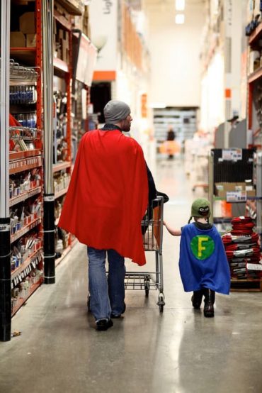 Father & son in matching superhero capes, browsing the aisles of Home Depot for supplies – best pic ever!
