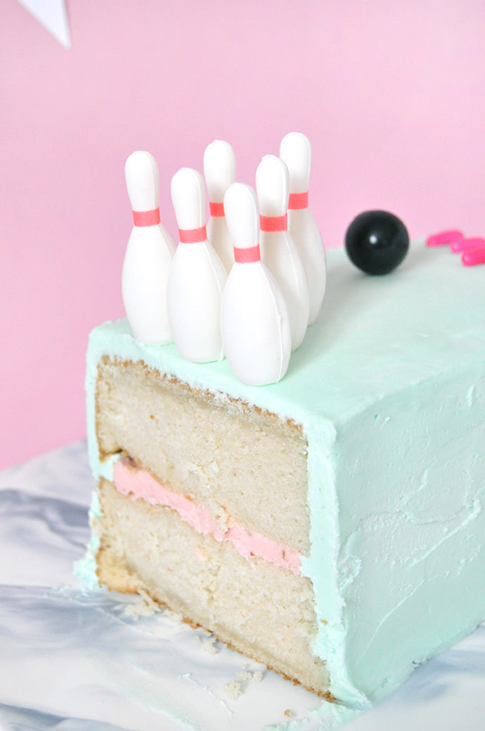 Delicious Cake Design - A fun bowling cake for a bowling birthday party!  The bowling pins and bowling ball were hand crafted from fondant. The lane  was created from fondant decorated with